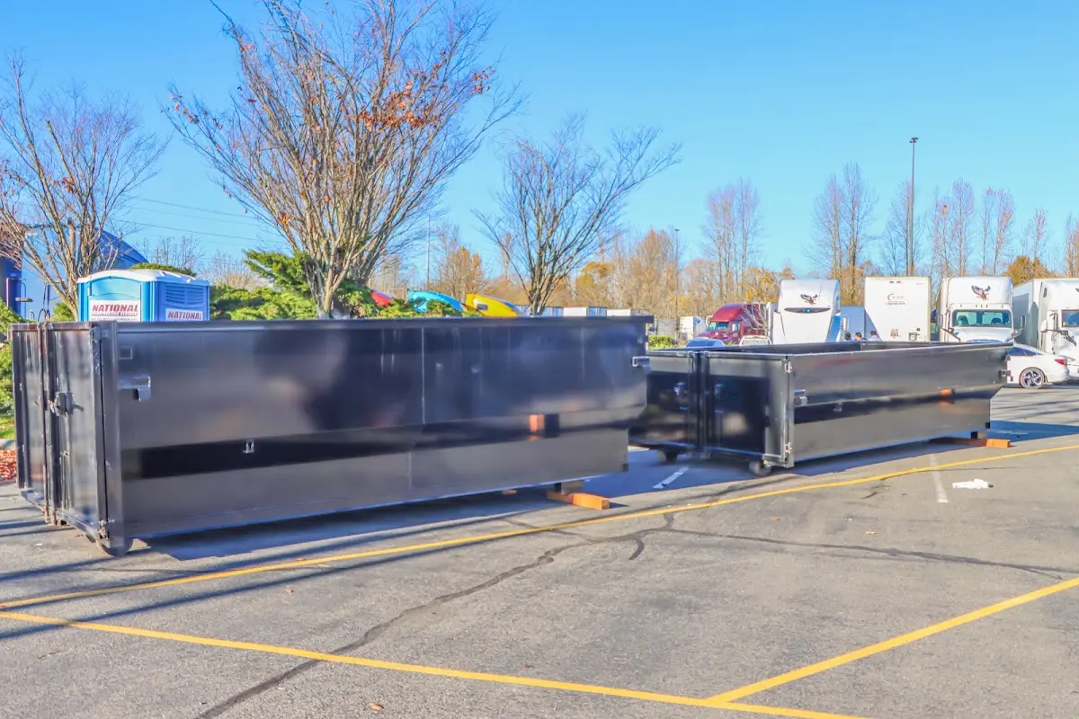Professional dumpster rental service with roll-off container on residential driveway in Marianna